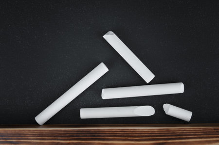 Few pieces of chalk close up on blackboardの写真素材