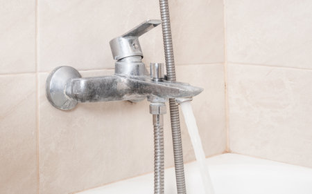 Dirty faucet aerator with limescale, calcified shower water tap with lime scale in bathroomの写真素材