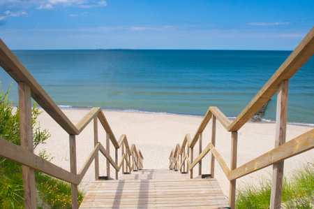 Wooden stairs leading to the empty sand beachの写真素材