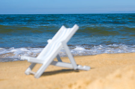 Unfocused empty sun lounger at a sandy beach. Back focusの写真素材