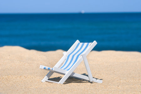 Empty sun lounger at a sandy beachの写真素材