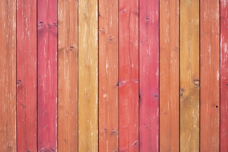 Wooden table or planks fence, red-orange background, texture.の写真素材