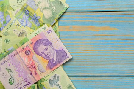 Various Romanian banknotes on a wooden table, 1-5 leu. Europe Hungary.