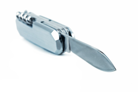 silver multi purpose clasp knife with focus of the blade Isolated on white background