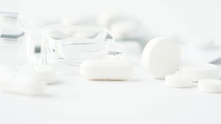White medical pills,close-up on white background. Closeup photo of medical preparations with copy...