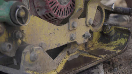 Vibratory asphalt paving machine on the sidewalk filmed close-up.Road works,pavement repair,hard work.Video clip.の写真素材