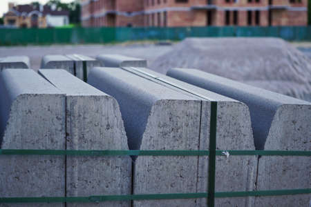 Concrete curbs on wooden pallets stand on the street during street repair. Road works, sidewalk repairの写真素材
