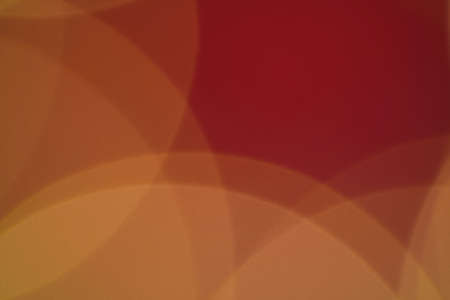 Blurred Christmas lights background texture, defocused illumination as background. Bright orange semicircles on a red background, abstract background.の写真素材