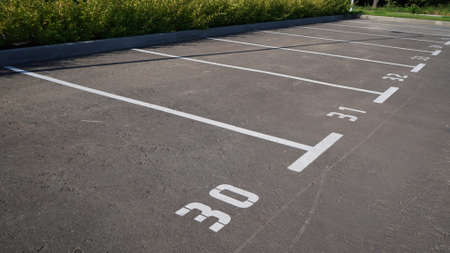 Close-up of a white paint number marking in a parking lot. Empty parking lot, Parking lot with white mark, Open parking in public park. Number 30の写真素材