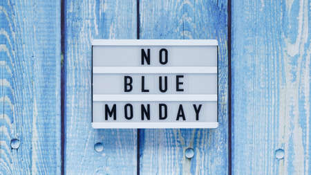 Blue monday day banner concept. White board with text no blue monday on blue wooden background, top view, flat layの写真素材
