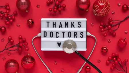 Christmas medical banner, letter board with text thanks doctors, red balls, berries, stars and...