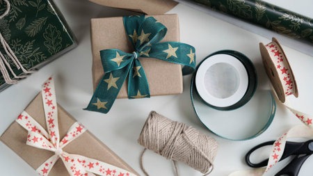 Gift boxes tied with beautiful ribbons with pattern stars with bow.Rolls wrapping...