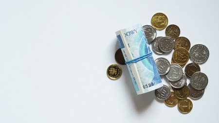 Close-up of zloty banknotes and coins on a white background, Polish currency. The concept of currency exchange in another country.Inflation and taxes in the European Union. Selective focus.Copy spaceの写真素材