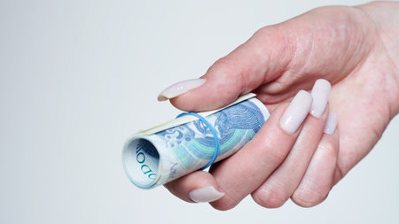 Close-up of female hands counting money,salary in zlotys,Polish currency.Concept of currency exchange in another country.Inflation and taxes in European Union.Payment for purchases.Copy spaceの写真素材