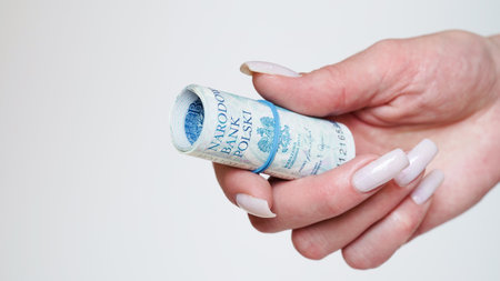 Close-up of female hands counting money,salary in zlotys,Polish currency.Concept of currency exchange in another country.Inflation and taxes in European Union.Payment for purchases.Copy spaceの写真素材