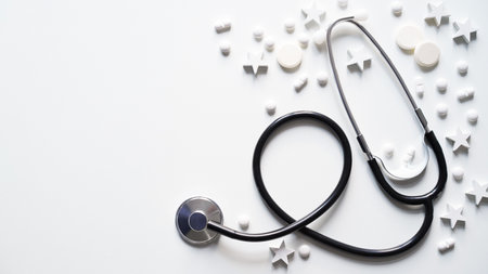Christmas medical banner. Close-up of stethoscope, stars and pills on white background, top view, flat lay, copy space. New Year's medicine, congratulations to the doctorの写真素材