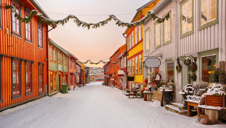Street in the norwegian town Roeros during colorful winter sunriseの写真素材