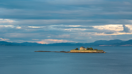 Island Munkholmen located in the Trondheim fjord near the Norwegian city Trondheim during sunsetのeditorial素材