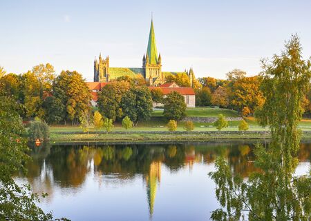 River Nidelva and the cathedral Nidarosdomen in the Norwegian city Trondheimの写真素材