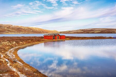 First snow in October at the lake Orkel located in the Oppdal area, Norwayの写真素材