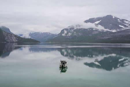 View of the norwegian fjord Indrefjorden and Moeysalen National Park in the summer foggy day