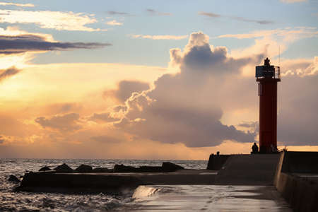 Mangalsala lighthouse located in Rigas bay in the Latvian capital Riga during colorful summer sunset