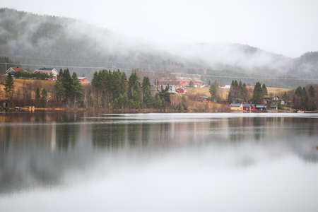 the autumn view of the lake Selbu and village Broettem located in the Trondelag, Norway , in the...