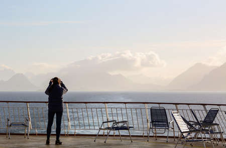 Cruise ship tourist taking picture of the Norwegian Lofoten islandsの写真素材