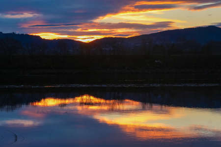 Sunset at the river Gaula with view of the Oesanden agricultural area located near the Norwegian city Trondheimの写真素材