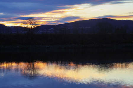 Twilight at the river Gaula , view of the Oesanden agricultural area and sea buckthorn tree silhuetteの写真素材