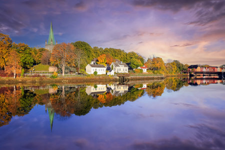 Fall in Trondheim, view of the cathedral Nidarosdomen  and the river Nidelva during sunsetの写真素材