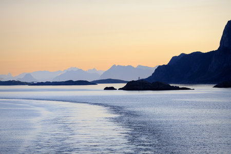 Sunset at the Lofoten islands, mountains silhouettes on the way to the town Svolvaerの写真素材