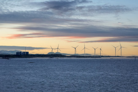 Wind turbines park on the Norwegian offshore at sunset