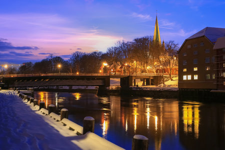 Twilight in the snowy Trondheim, view of the Old Bridge ( den Gamle Bybru) og the river Nidelva