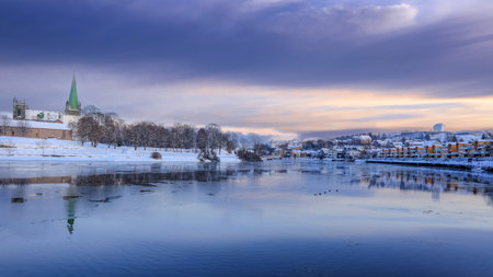 Winter in Trondheim, view of the river Nidelva and the cathedral Nidarosdomen reflected in the water