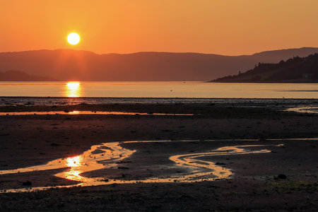 Low tide at Trondheim fjord and sandy beach Oesanden located near the Norwegian city Trondheim