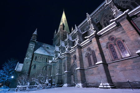 Nightly cathedral Nidarosdomen in Trondheim covered with snow after snowfall in Decemberの写真素材