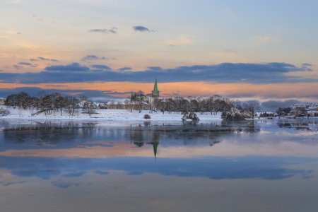 Winter in Trondheim, view of the river Nidelva and the cathedral Nidarosdomenの写真素材