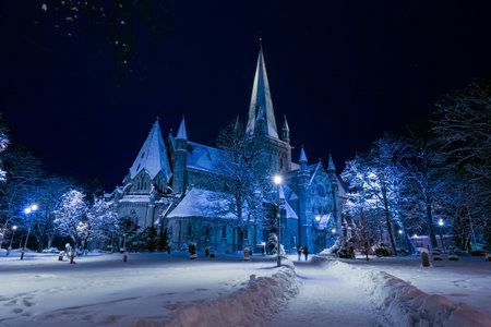 Nightly cathedral Nidarosdomen in the Norwegian city Trondheim covered with snow after snowstormの写真素材