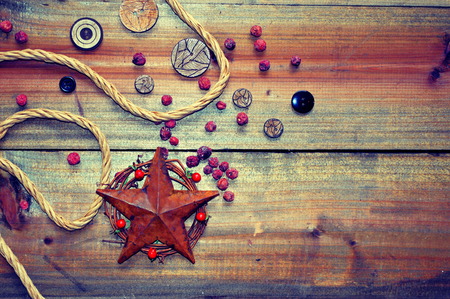 Decorative star element with buttons on a wooden backgroundの写真素材