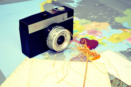 Old retro camera with world map