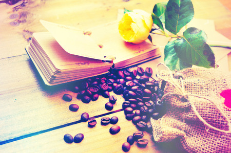 Coffee grains with flowers on a wooden backgroundの写真素材