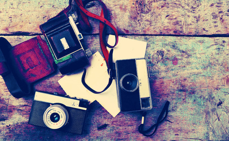 Old retro cameras on vintage wooden backgroundの写真素材