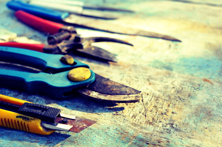 Garden scissors and knifes set on a wooden backgroundの写真素材