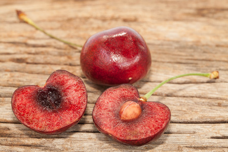 Cherry fruits on the old wood backgroundの写真素材