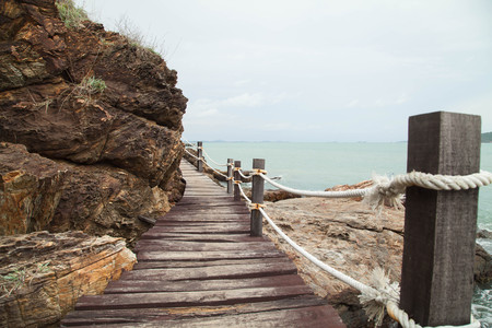 Travel on the old wooden walkway near the beachの写真素材