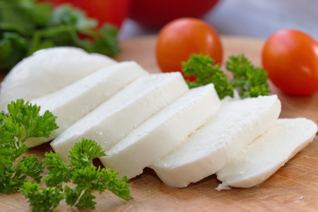 Mozzarella and vegetables on the wooden table