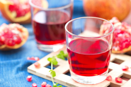 Pomegranate Juice and Fresh Ripe Pomegranatesの写真素材