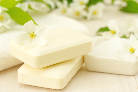 SPA setting. Jasmin soap and flowers and on a wooden tableの写真素材