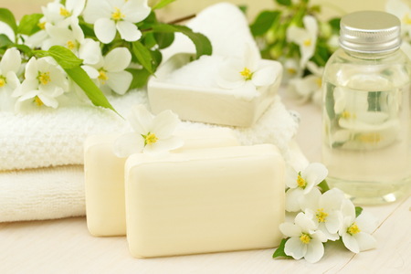 SPA setting. Jasmin soap and flowers and on a wooden tableの写真素材